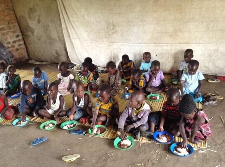 Children eating a meal at a CGALU community outreach